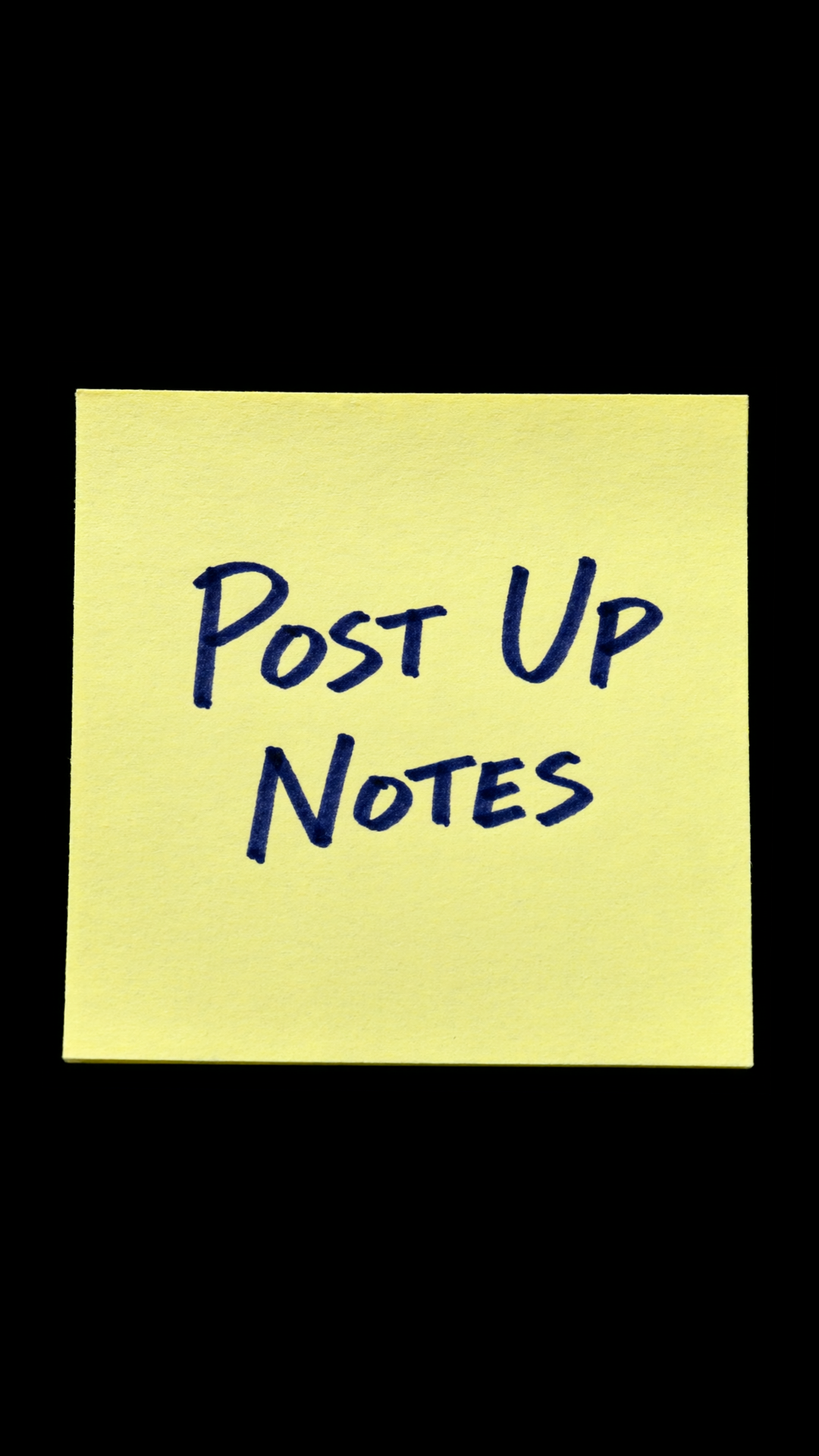 A yellow sticky note on black with Post Up Notes handwritten in dark blue ink.